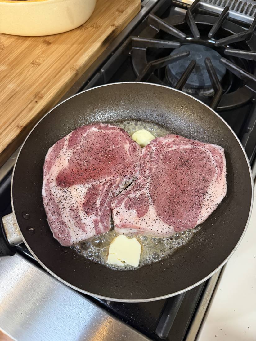 Thick-cut Woodcock Livestock pork chops going into the pan