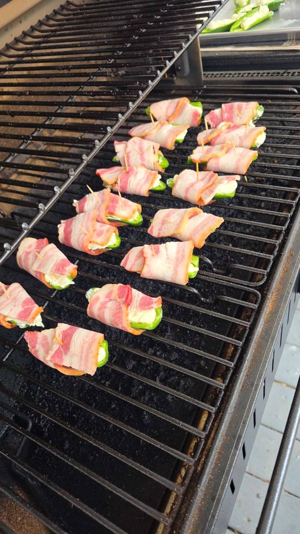 Bacon-wrapped jalapeño poppers on the grill made with Woodcock Livestock bacon