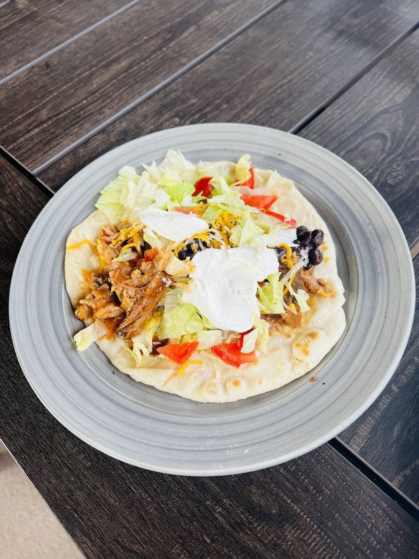 Sweet barbacoa pulled pork tostada made from a Woodcock Livestock pork shoulder